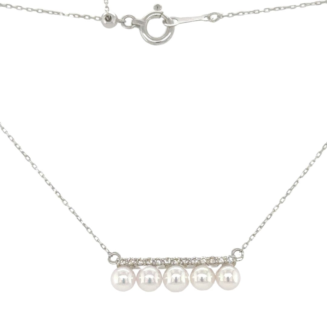 Introducing our 5 Pearl White Gold Pendant, a harmonious blend of timeless sophistication and natural beauty. This exquisite piece features a delicate row of round diamonds suspended in a graceful line, above a quintet of lustrous pearls, creating a design that captures the essence of refined luxury