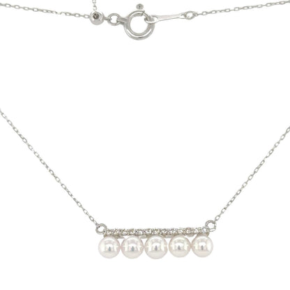 Introducing our 5 Pearl White Gold Pendant, a harmonious blend of timeless sophistication and natural beauty. This exquisite piece features a delicate row of round diamonds suspended in a graceful line, above a quintet of lustrous pearls, creating a design that captures the essence of refined luxury